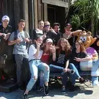 groupe d adolescents souriants devant une attraction de parc